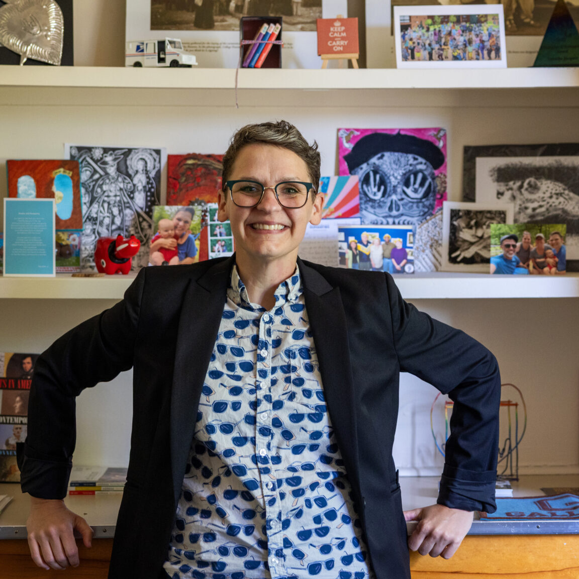A photo of Tabitha Jacques wearing a navy blazer and blue patterned shirt.